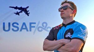 Man wearing Cloud 9 jersey in front of military jet